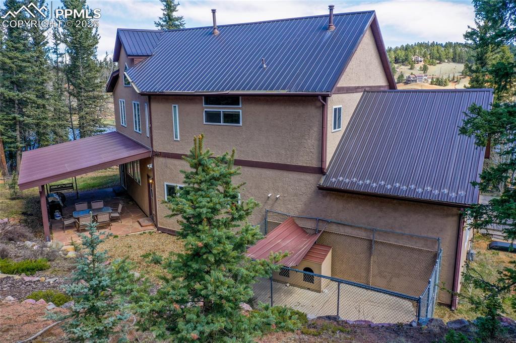 1427 Spring Valley Drive Divide, CO 80814 - Photo 12 of 50 a backyard of a house with table and chairs