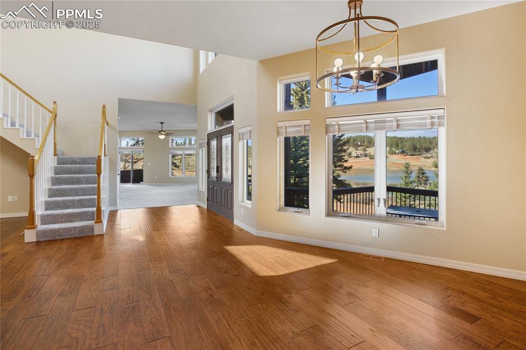1427 Spring Valley Drive Divide, CO 80814 - Photo 15 of 50 a view of an empty room with wooden floor fireplace and a window