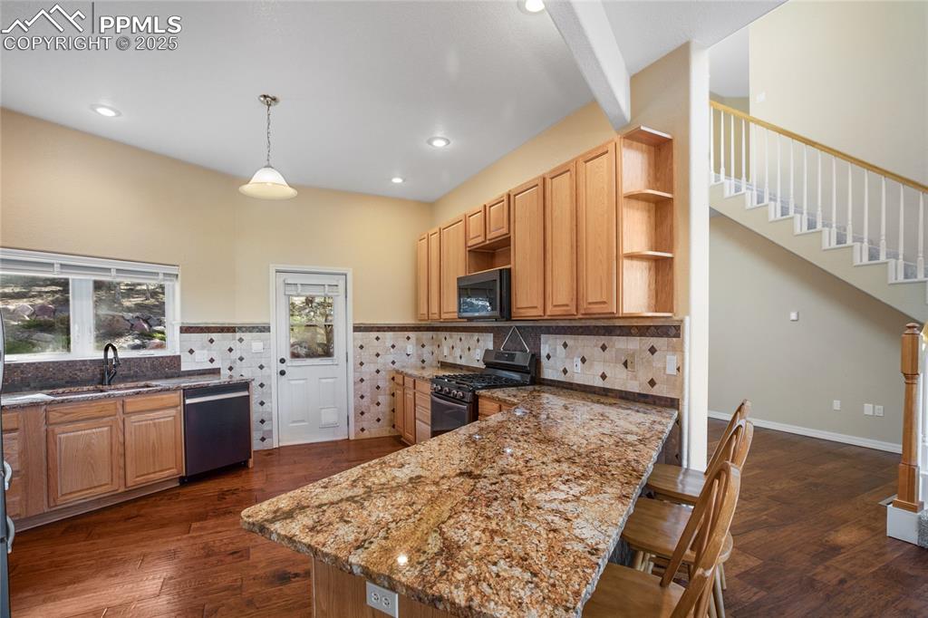 1427 Spring Valley Drive Divide, CO 80814 - Photo 26 of 50 a kitchen with stainless steel appliances granite countertop a sink stove and refrigerator