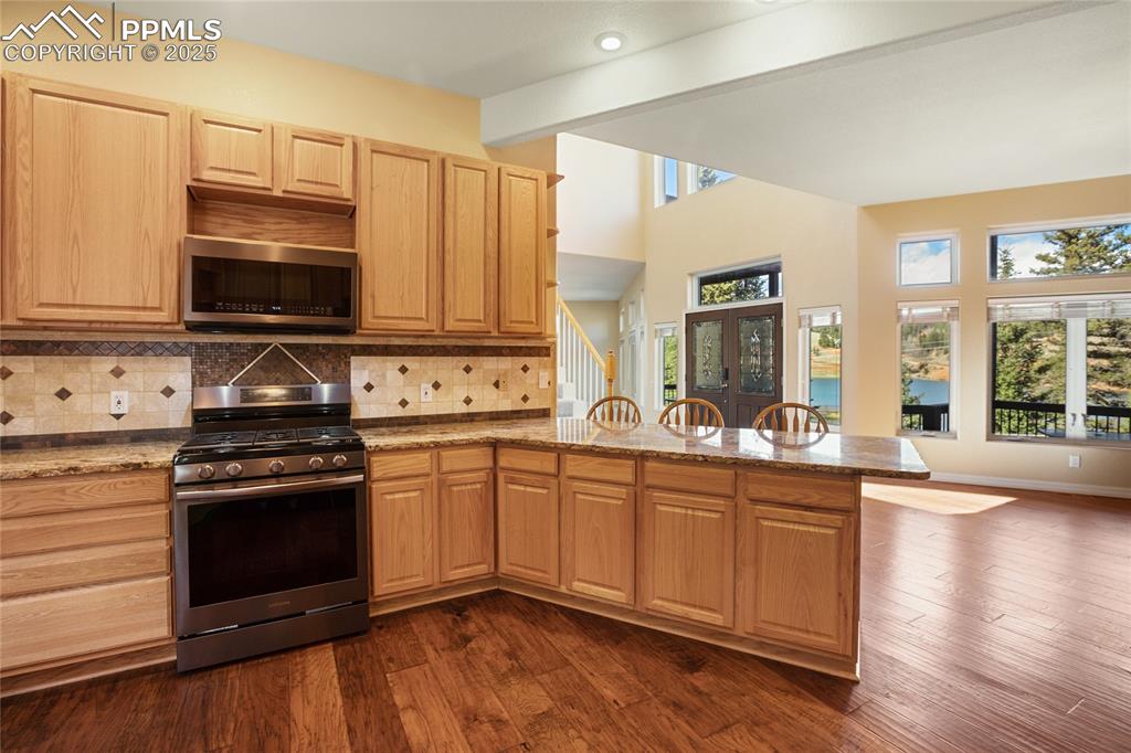 1427 Spring Valley Drive Divide, CO 80814 - Photo 29 of 50 a kitchen with a stove a sink and a microwave