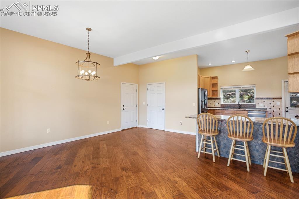 1427 Spring Valley Drive Divide, CO 80814 - Photo 32 of 50 a view of a dining room with furniture wooden floor and chandelier