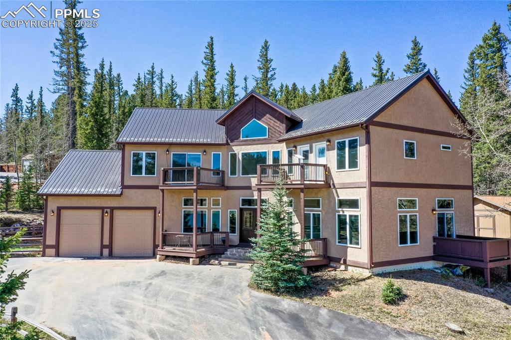1427 Spring Valley Drive Divide, CO 80814 - Photo 5 of 50 a front view of a house with garden