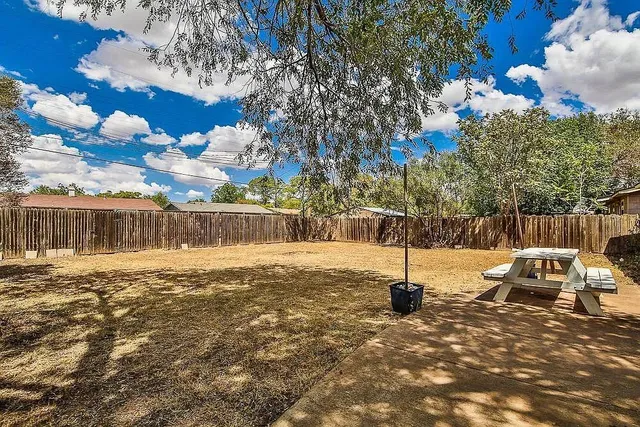 a swimming pool with some trees in the background
