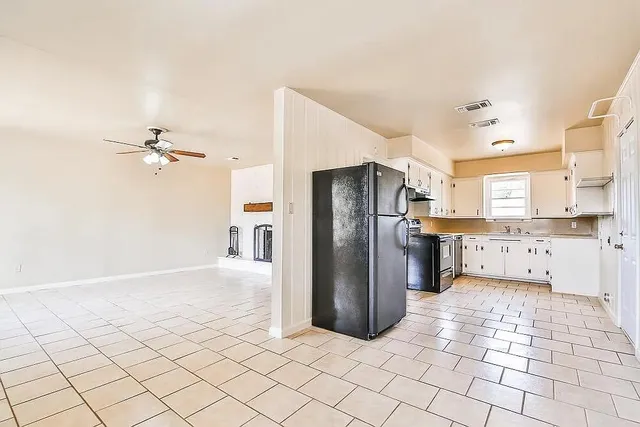 a kitchen with stainless steel appliances a refrigerator and a stove top oven