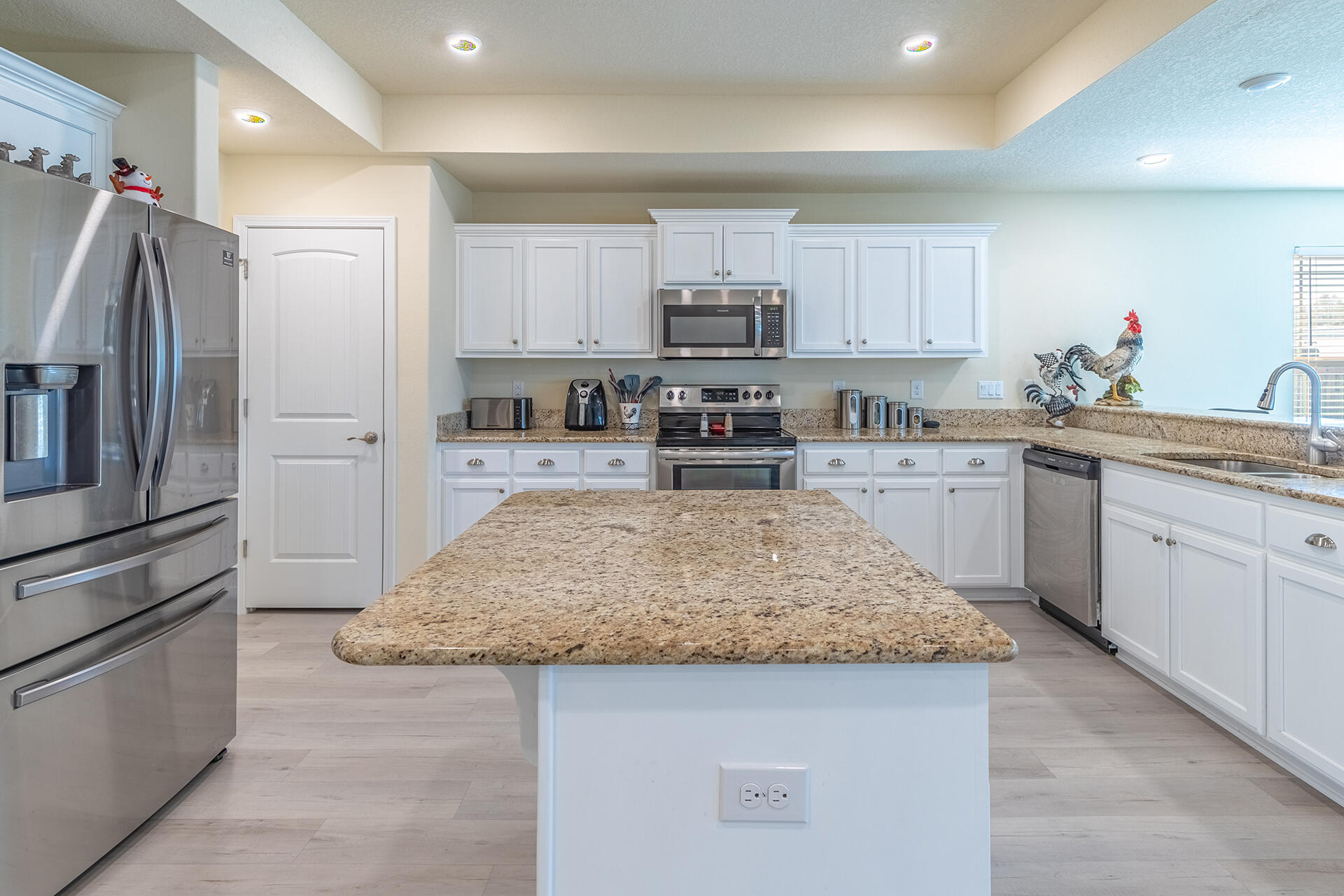 3639 Ranch Drive Crestview, FL 32539 - Photo 17 of 40 a kitchen with stainless steel appliances granite countertop a sink stove refrigerator and cabinets