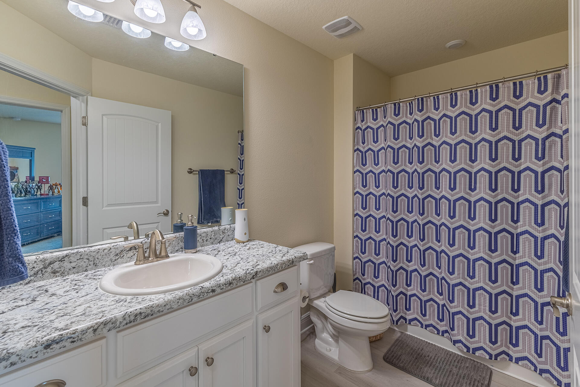 3639 Ranch Drive Crestview, FL 32539 - Photo 23 of 40 a bathroom with a granite countertop toilet sink and mirror