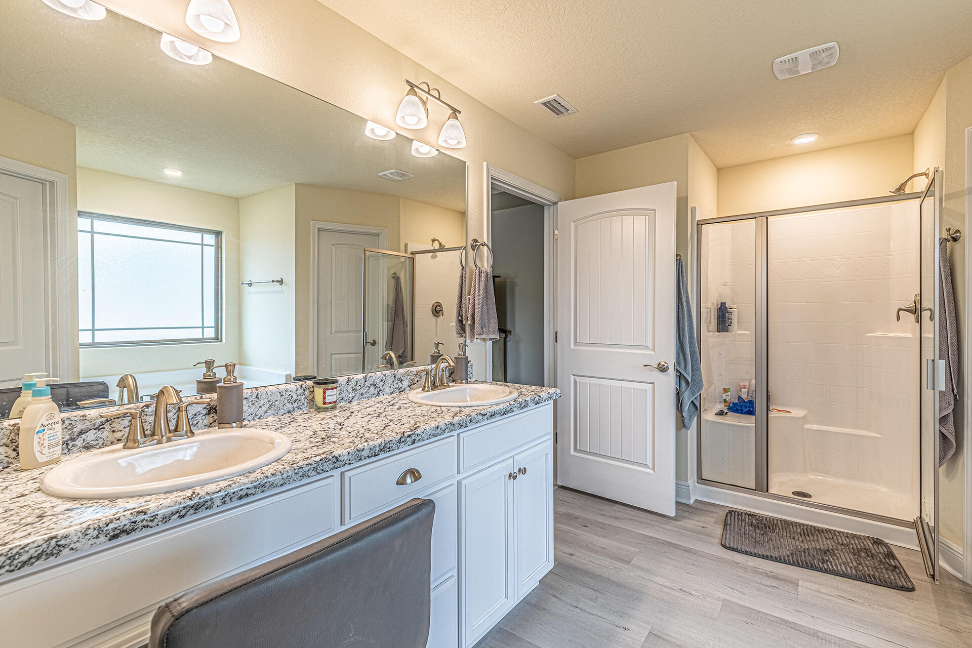3639 Ranch Drive Crestview, FL 32539 - Photo 26 of 40 a bathroom with a granite countertop sink mirror and a shower