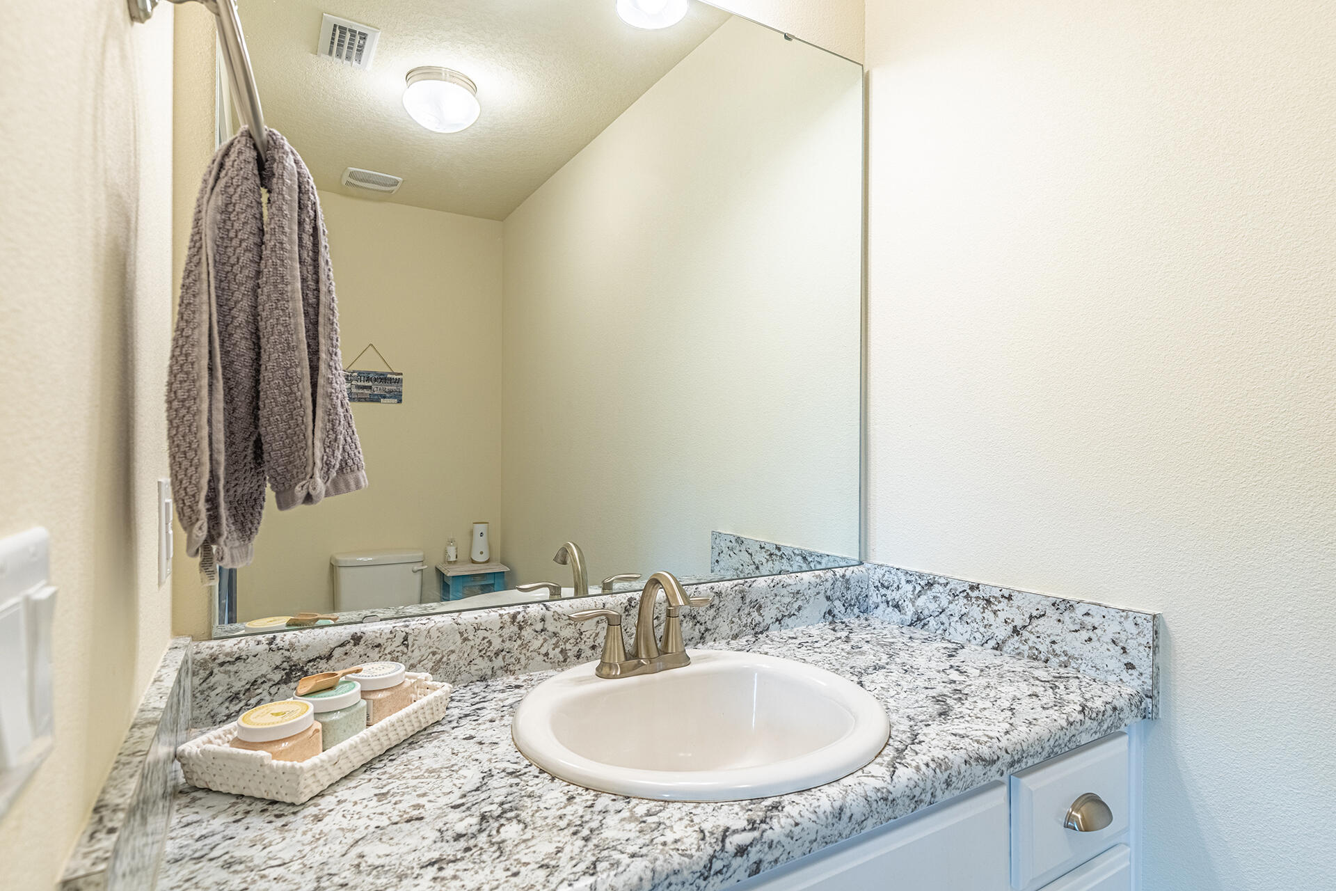 3639 Ranch Drive Crestview, FL 32539 - Photo 31 of 40 a bathroom with a granite countertop sink and a mirror