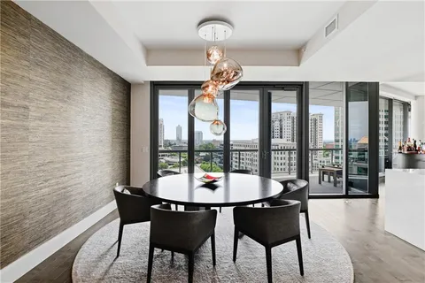 a living room with furniture a flat screen tv and a large window