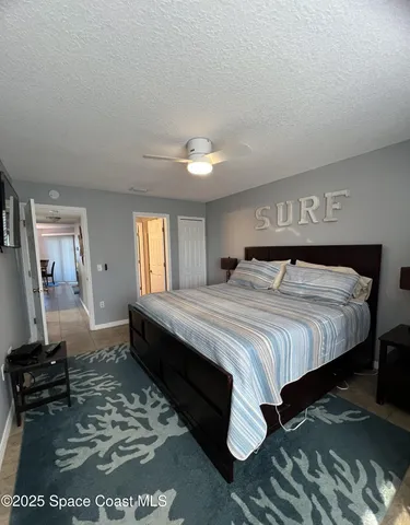 a bedroom with a bed and dresser with mirror