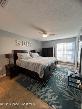 a bedroom with a bed and dresser with mirror