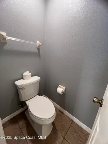 a white toilet sitting next to a bathroom sink