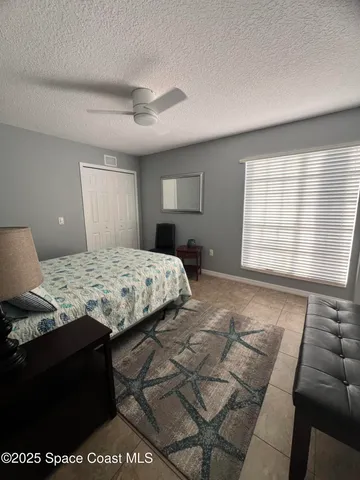 a bedroom with a bed and a night stand