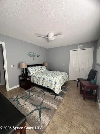 a bedroom with a bed and a night stand