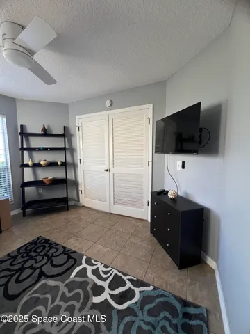 a bedroom with a bed and flat screen tv