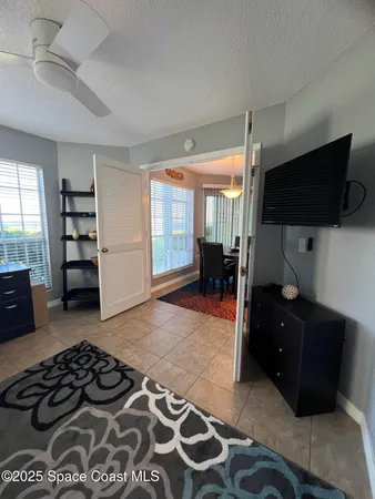 a bedroom with a bed and flat screen tv