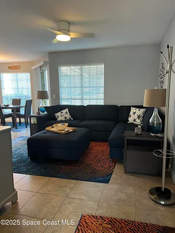 a living room with furniture rug and window