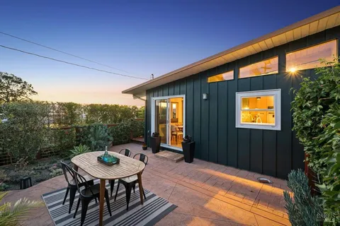a view of a patio with a table and chairs