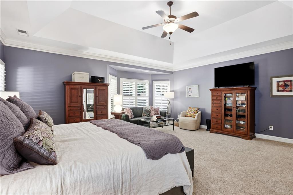 3211 Collier Gate Court Smyrna, GA 30080 - Photo 17 of 40 a bedroom with a bed a couch and a flat tv screen