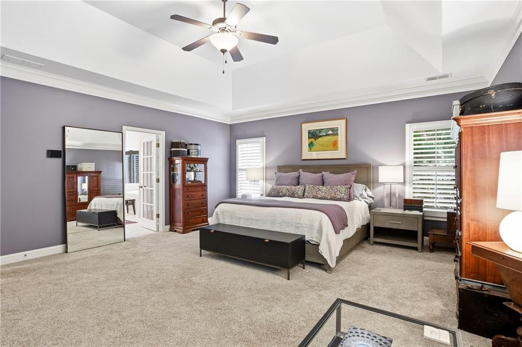 3211 Collier Gate Court Smyrna, GA 30080 - Photo 18 of 40 a spacious bedroom with a bed a couch and a chandelier