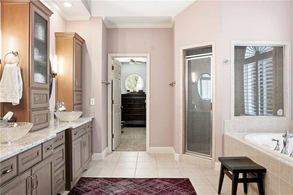 3211 Collier Gate Court Smyrna, GA 30080 - Photo 20 of 40 a spacious bathroom with a shower a sink and a mirror
