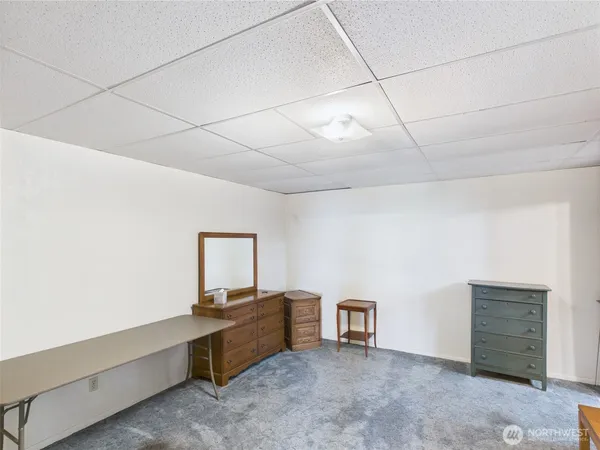 a gym room with lots of furniture and a chandelier
