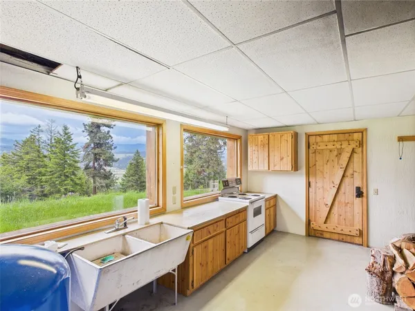 a bathroom with a granite countertop sink a toilet and shower