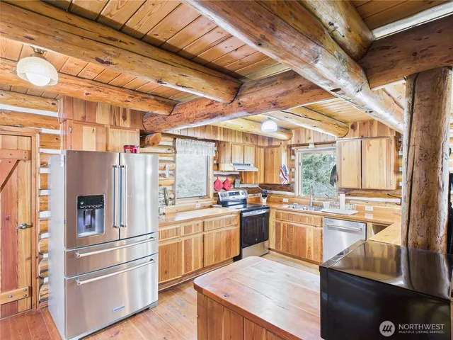 a kitchen with granite countertop stainless steel appliances and wooden cabinets