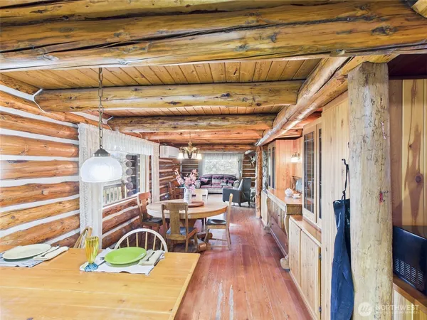 a view of a hallway with wooden floor and furniture