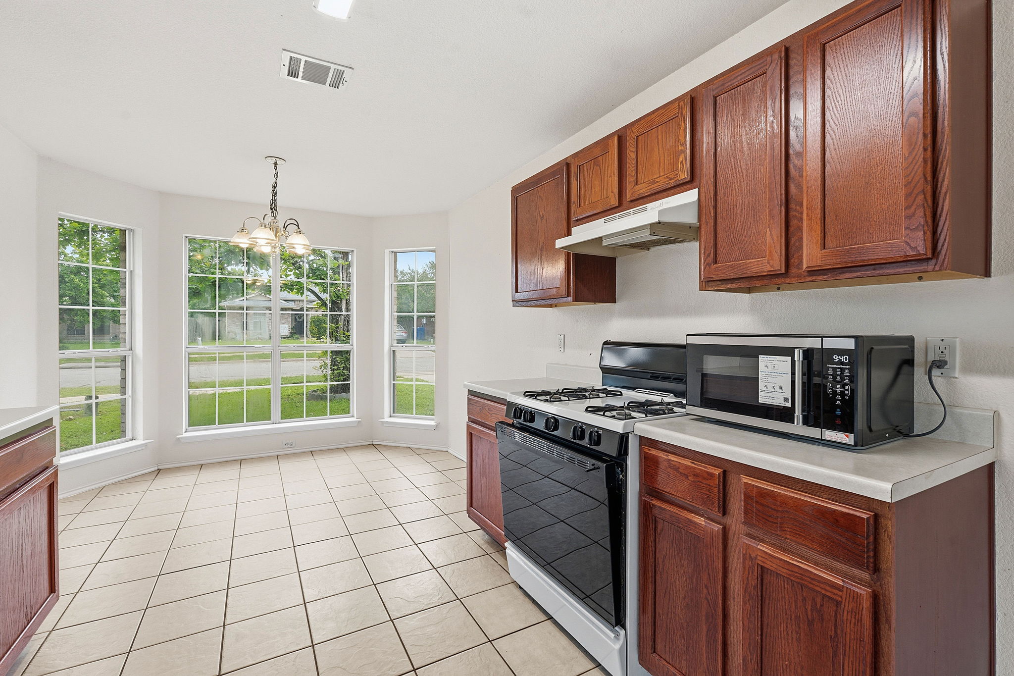116 Blue Ridge Trail Elgin, TX 78621 - Photo 10 of 28 a kitchen with a stove sink and cabinets