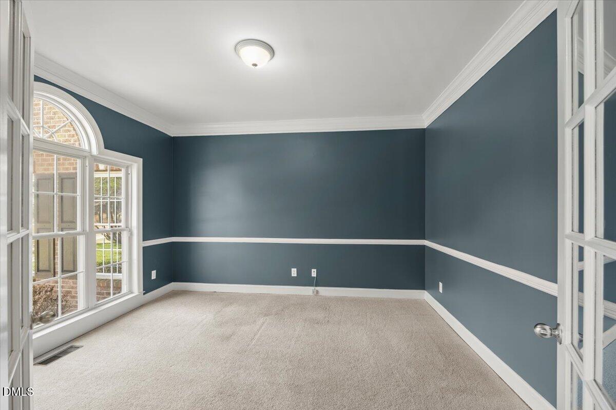 7828 Percussion Drive Apex, NC 27539 - Photo 14 of 88 a view of an empty room with a window
