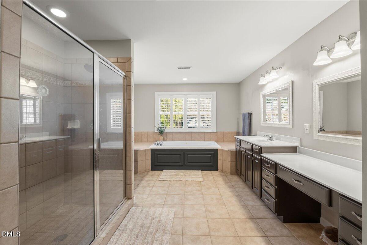 7828 Percussion Drive Apex, NC 27539 - Photo 46 of 88 a large spacious bathroom with a large tub shower and sink