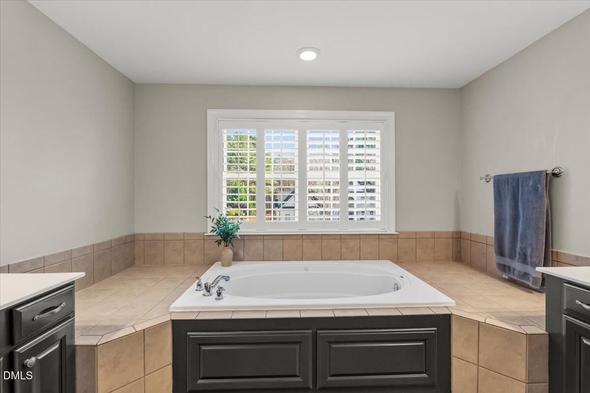 7828 Percussion Drive Apex, NC 27539 - Photo 48 of 88 a bathroom with a sink and a bathtub