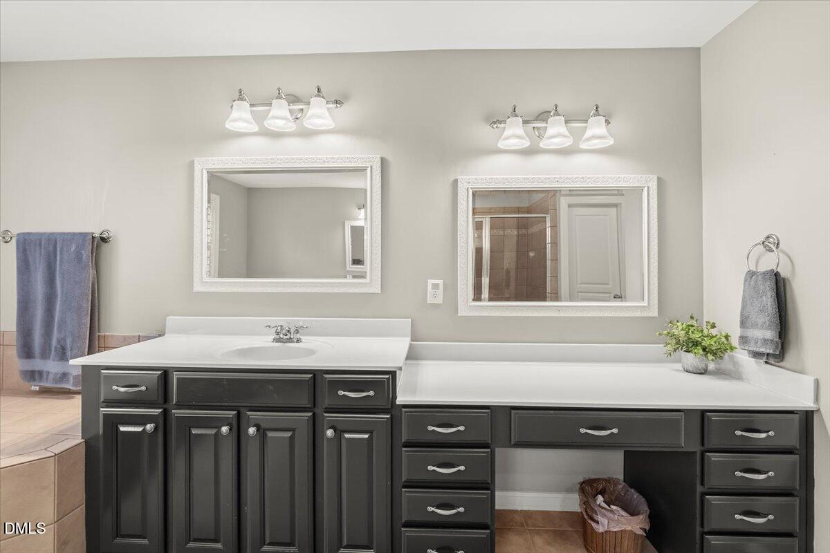 7828 Percussion Drive Apex, NC 27539 - Photo 50 of 88 a bathroom with a sink vanity and a mirror