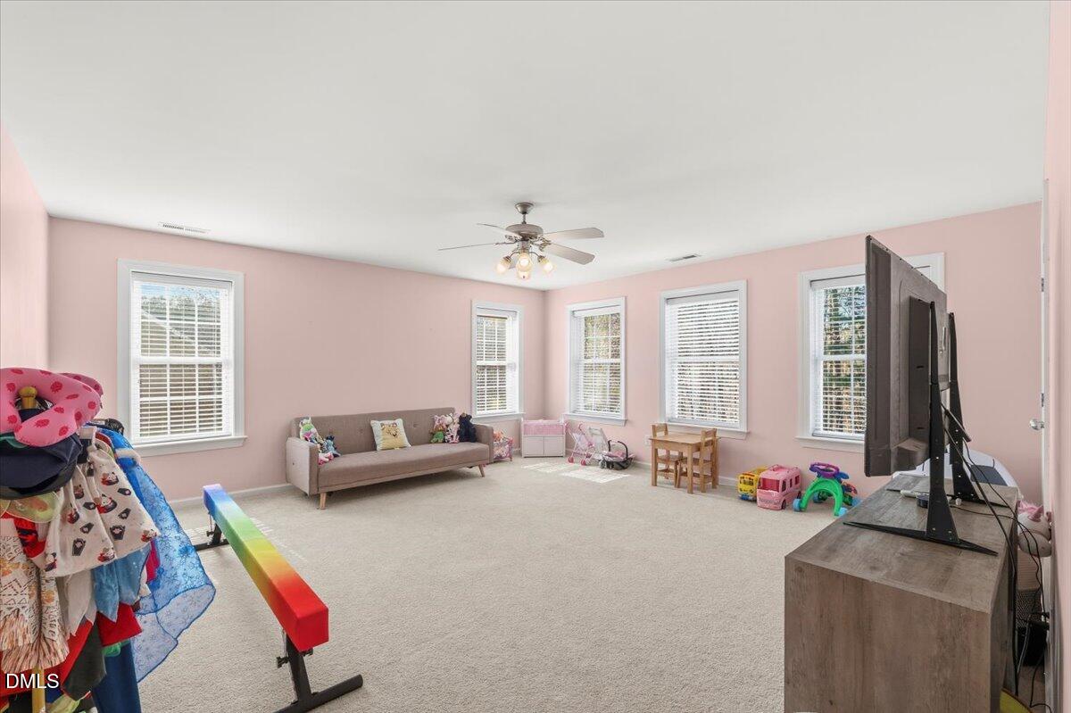 7828 Percussion Drive Apex, NC 27539 - Photo 53 of 88 a living room with furniture and a flat screen tv