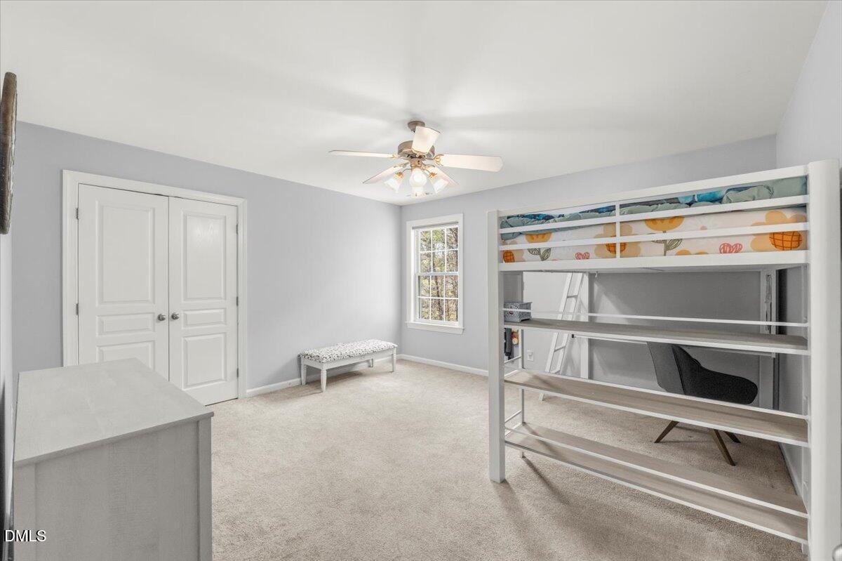 7828 Percussion Drive Apex, NC 27539 - Photo 55 of 88 a living room with furniture and a chandelier