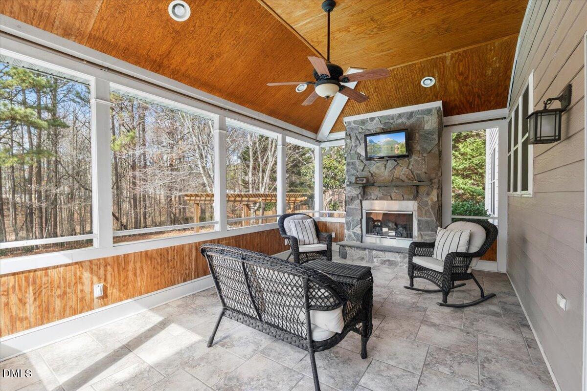 7828 Percussion Drive Apex, NC 27539 - Photo 70 of 88 a dining room with furniture a floor to ceiling window and a chandelier