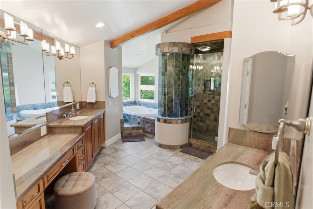 31233 Romero Canyon Road Castaic, CA 91384 - Photo 22 of 38 a spacious bathroom with a double vanity sink a toilet a mirror and shower