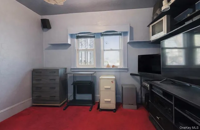 a view of room with flat screen tv and a window