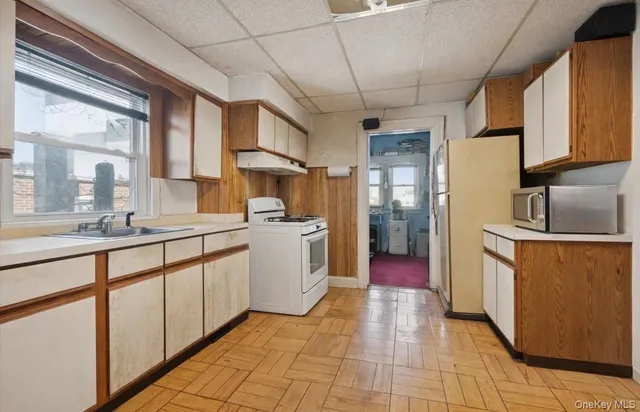 a kitchen with sink cabinets and window
