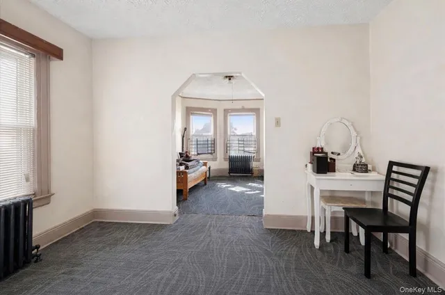 a view of a room that has a couch and a stove in it