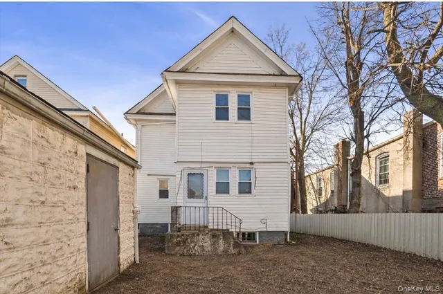 a view of a white house with a large windows