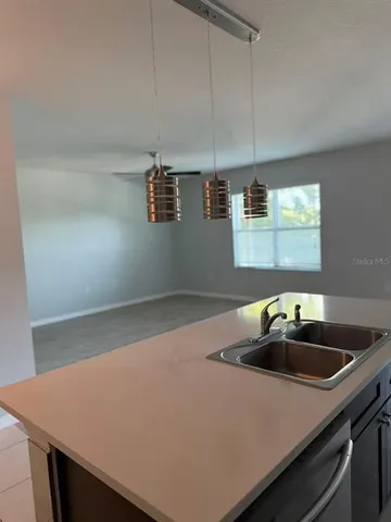 a kitchen with a sink a stove and cabinets