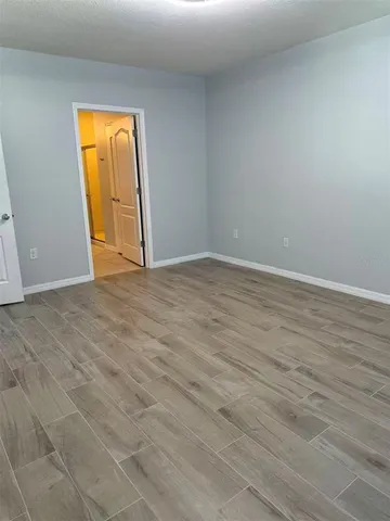 a view of an empty room with a closet