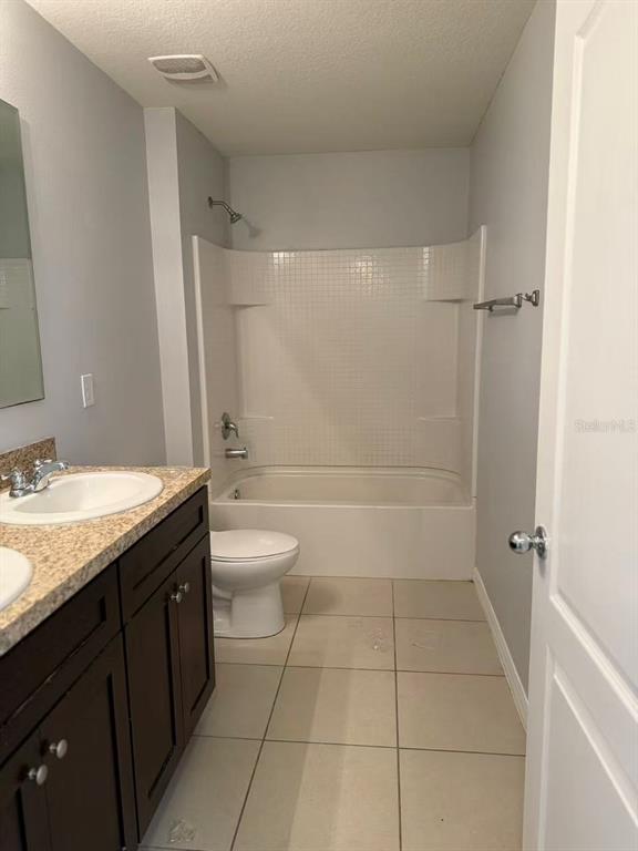2114 Rockmart Loop Tavares, FL 32778 - Photo 8 of 18 a bathroom with a granite countertop sink toilet and shower