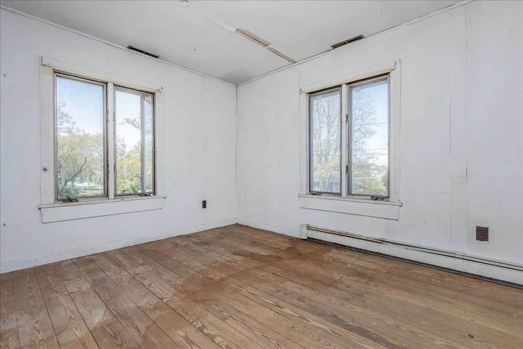 88 Marion Road Scituate, MA 02066 - Photo 21 of 41 a view of an empty room with wooden floor and a window
