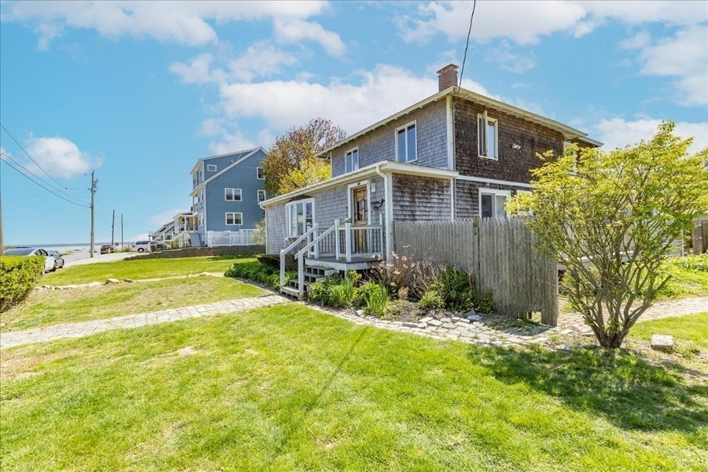 88 Marion Road Scituate, MA 02066 - Photo 27 of 41 a front view of house with yard and trees in the background