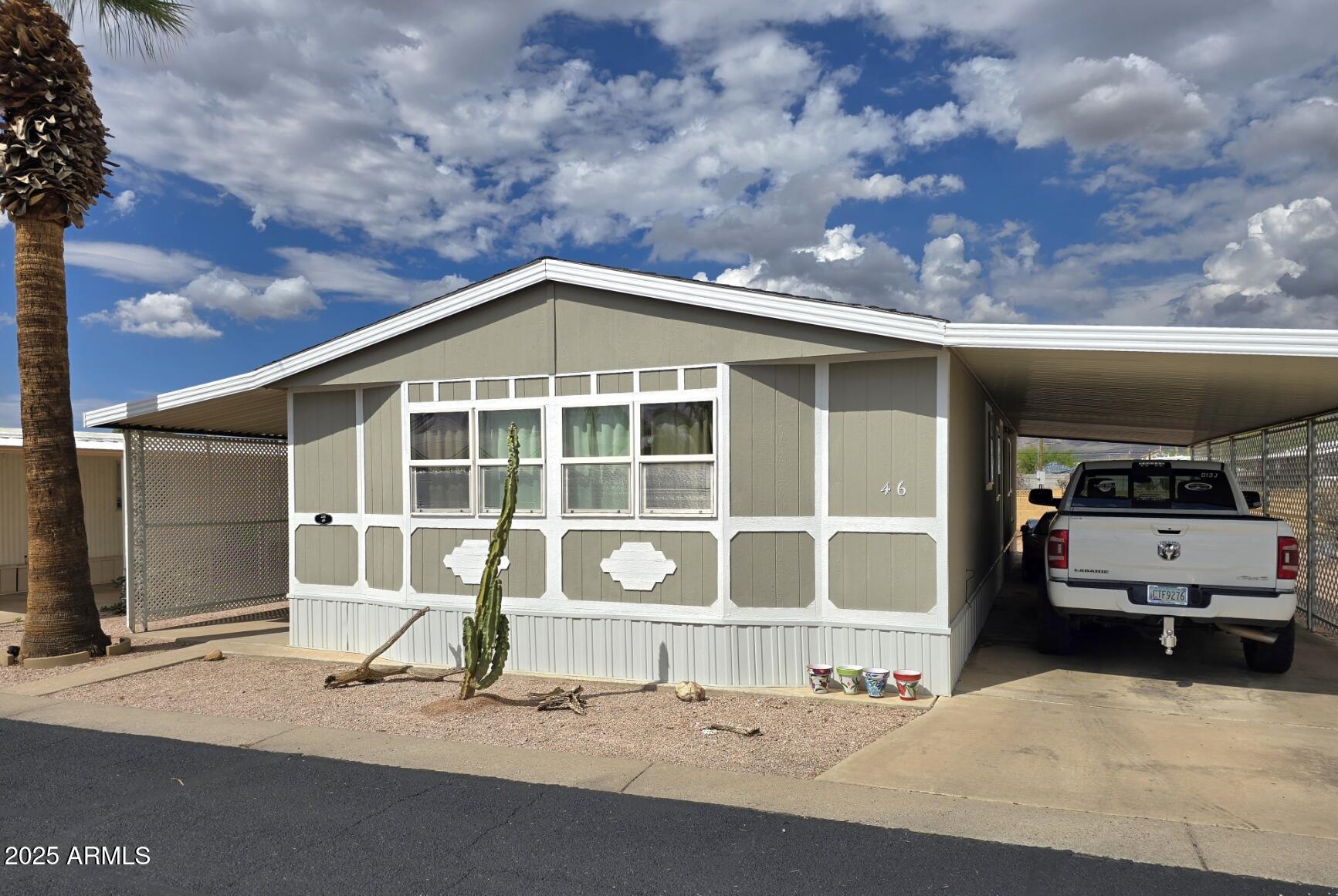 2900 West Superstition Boulevard, Unit 46 Apache Junction, AZ 85120 - Photo 1 of 26 a front view of a house with a yard