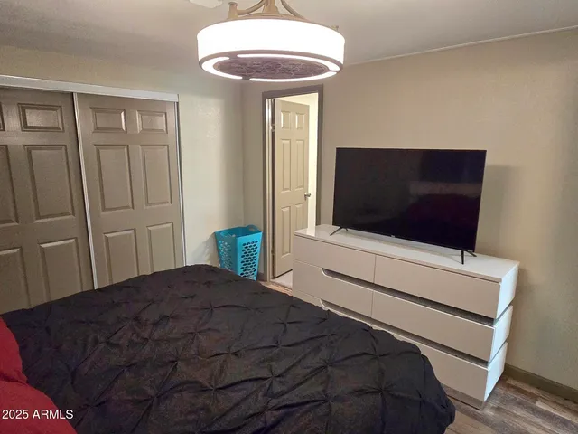 a bedroom with a bed and a flat screen tv