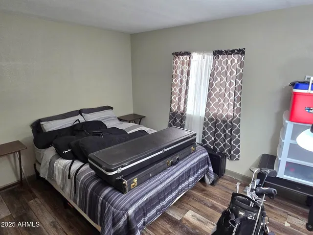 a view of a hallway with wooden floor and stairs